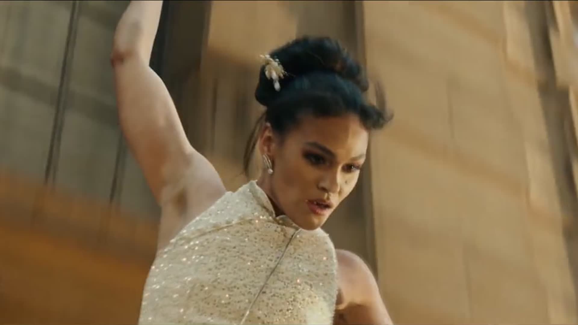 A woman descending the side of a building in Soul Sisters